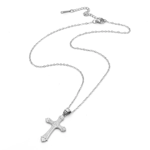 Detailed close-up of a silver cross pendant with intricate floral engravings on a link chain