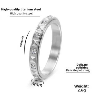 Detailed 3mm wide silver titanium ring showing pyramid studs and cubic zirconia inlay