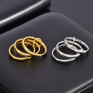 Macro shot of interlocking triple ring bands in polished gold and silver finishes