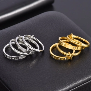Macro detail of intertwined gold and silver rings with Roman numerals and small diamonds