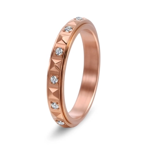 Macro detail of rose gold pyramid rivet ring with sparkling white pave set crystals