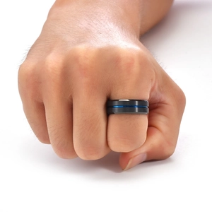 Close-up of 8mm black tungsten ring with blue groove and beveled edges on hand