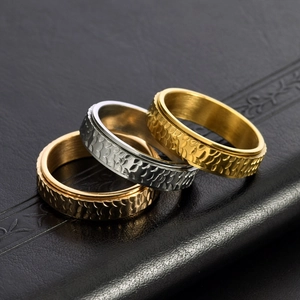 Mens textured stainless steel spinner rings in gold, silver and bronze on leather