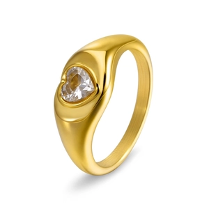 Macro view of wide gold ring band featuring a centered heart-cut sparkling cubic zirconia