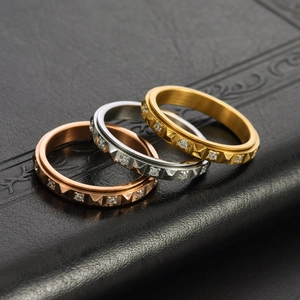 Rotating pyramid stud rings with diamonds in gold, silver, and rose gold finishes