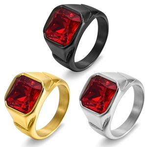 Detailed view of square red gemstones on men's rings in black, gold, and silver finishes