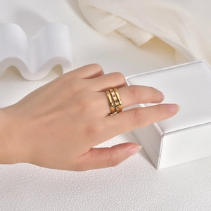 Detail of 18K gold layered titanium rings set with colorful zircons on model hand