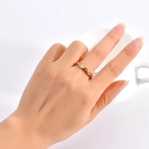 Detailed view of an 18K gold pyramid rivet ring with sparkling inlaid diamonds