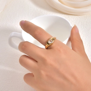 Gold plated heart ring for women made of stainless steel shown on hand at a 45-degree angle