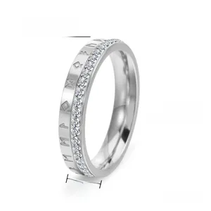 Macro shot of 4mm silver steel ring with Nordic runes and sparkling zircon stones