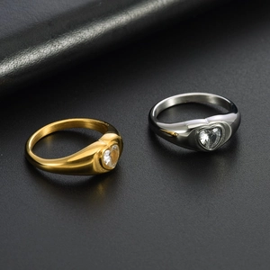 Polished heart-shaped cubic zirconia ring in gold and silver finishes on leather