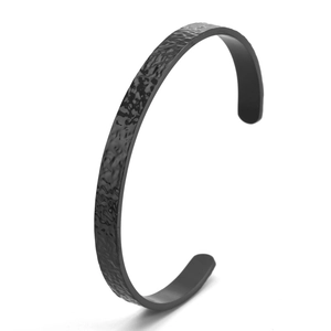 Minimalist matte black hammered stainless steel cuff bracelet with textured ripple design