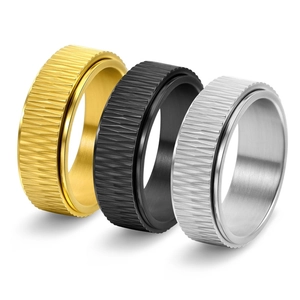 Detailed view of rotating titanium steel rings with geometric diamond patterns in three colors