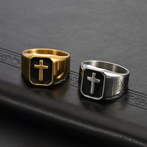 Macro detail of men's vintage cross ring featuring black enamel and intricate side carvings