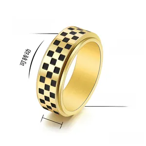 Detailed macro view of 8mm golden spinner ring featuring black checkered pattern and high polish