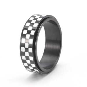 Macro view of rotating checkered black and white stainless steel spinner ring band