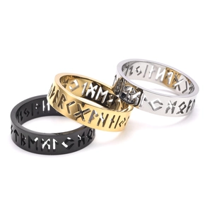 Detailed view of hollowed Viking runes on steel rings in black, gold, and silver finishes