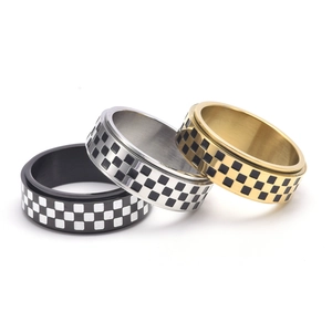 Three-piece checkered spinner ring set in black, silver and gold stainless steel