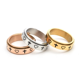Set of three rotating stainless steel rings with cross and heart engravings in three colors