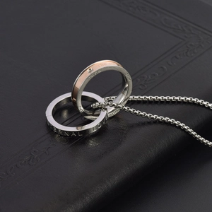 Macro detail of interlocking rings with Eternal Love engraving and sparkling zircon