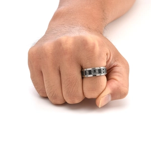 Detail of vintage rotating Tai Chi ring with engraved Bagua symbols in black and silver