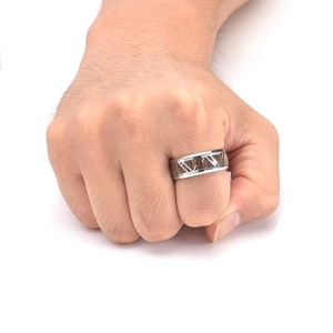 Detailed close-up of a men's titanium steel ring featuring inlaid wood and geometric patterns