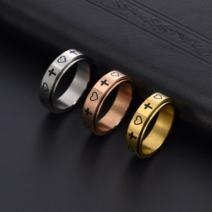 Detailed macro view of rotating stainless steel rings with cross and heart patterns