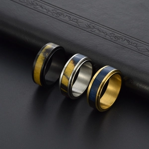 Three-piece set of spinning stainless steel rings with wood grain inlay in gold silver and black