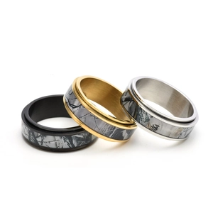 Three-piece stainless steel camouflage spinner rings set in black, gold, and silver finishes