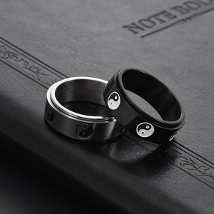 Detailed view of rotating black and silver stainless steel Yin Yang tai chi spinner rings