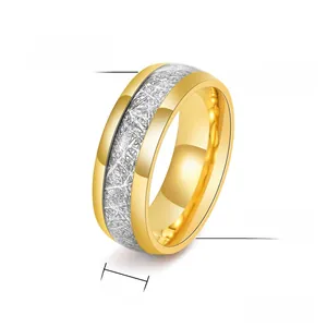 Macro detail of 8mm titanium steel ring with gold edges and meteorite texture finish