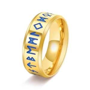 Macro shot of gold stainless steel Viking ring with blue Runic characters engravings
