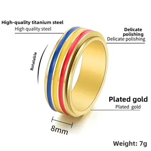 Close-up of 8mm rotating titanium ring with colorful enamel inlay and gold plating