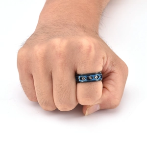 Close-up of rotatable stainless steel ring with blue layer showing zodiac symbols
