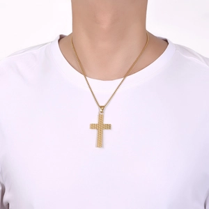 Close-up of golden stainless steel cross necklace with checkered pattern on male model