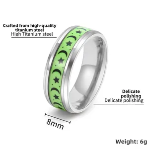 Detailed view of 8mm titanium steel ring featuring luminous star moon patterns