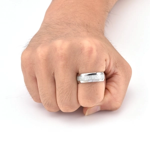 Close-up of men's wide silver titanium ring with frosted center and polished edges