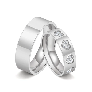 Polished silver titanium steel couple rings with sparkling zircon heart cutouts