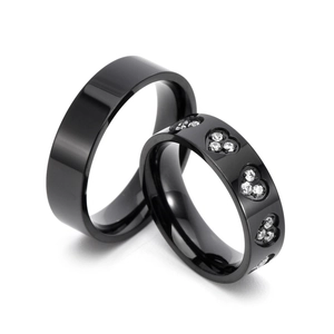 Polished black titanium steel ring set with heart-shaped diamond-encrusted accents