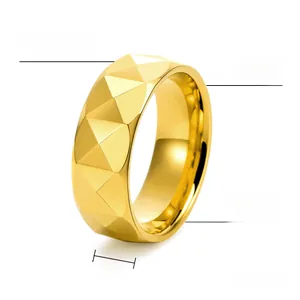 Detailed view of 8mm gold tungsten carbide ring with pyramid faceted surface texture