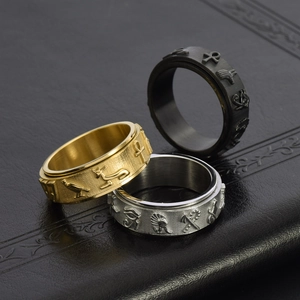 Three-piece set of spinner rings featuring Ancient Egyptian symbols in gold, silver, and black