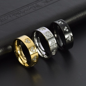 Polished stainless steel rings in gold, silver, and black with diamond-set heart patterns