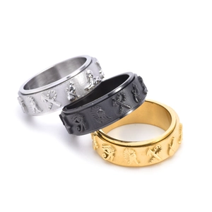 Detail macro of Egyptian symbol spinning rings in silver, black and gold steel finishes