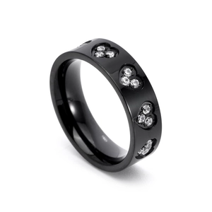Close-up of black stainless steel ring with heart patterns and inset cubic zirconia