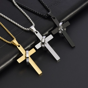 Three hip hop cross pendant necklaces in gold, silver and black on leather background