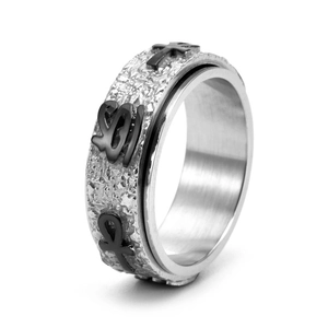 Detailed side view of silver and black spinner ring with engraved religious symbols