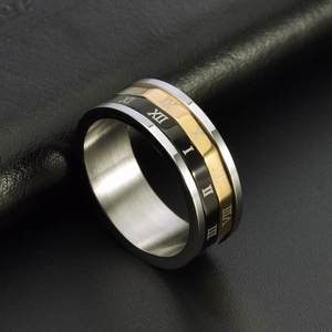 Three-tone stainless steel spinning ring with Roman numerals from a 45-degree angle