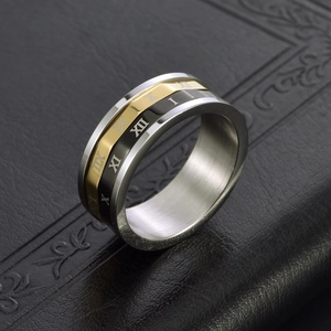 Three-tone stainless steel spinning ring with Roman numerals and geometric faceted edges