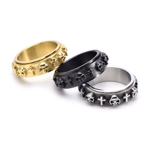 Vintage steel spinner rings with skull and cross relief in gold, black and silver