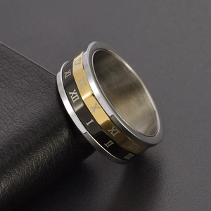 Three-tone stainless steel spinning ring with engraved Roman numerals on black base